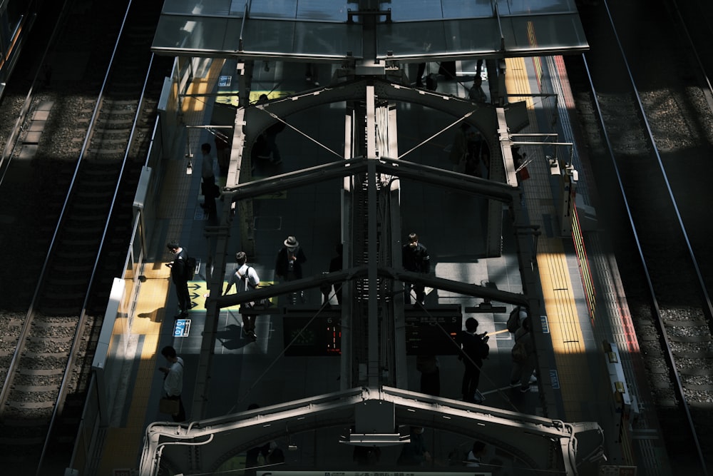 a group of people standing on top of a metal structure