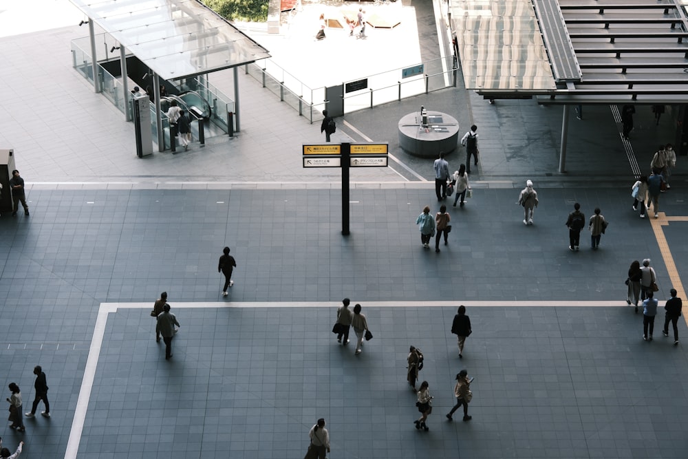 a group of people walking around a courtyard