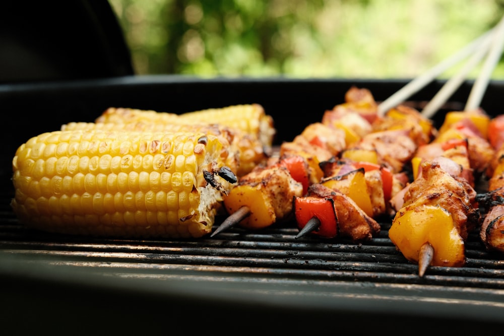 corn on the cob and meat on the grill