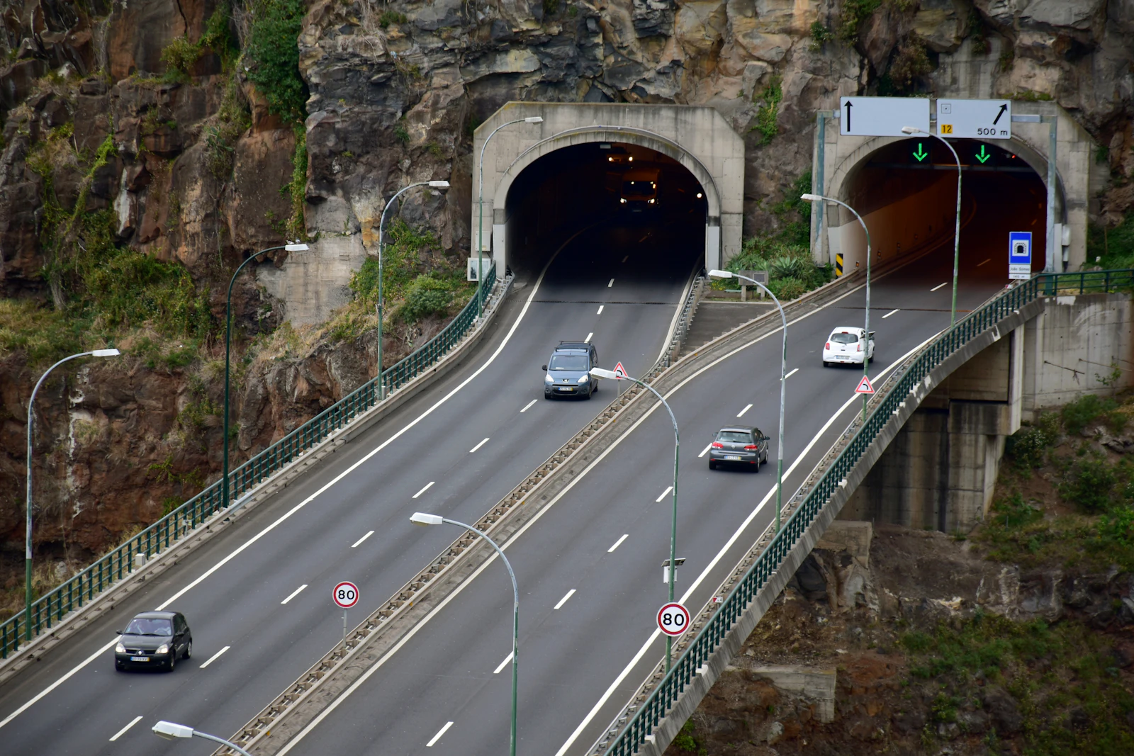 Traffic enters a mountain tunnel on Madeira