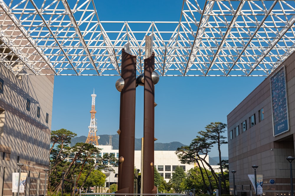 a couple of tall metal poles sitting under a metal roof