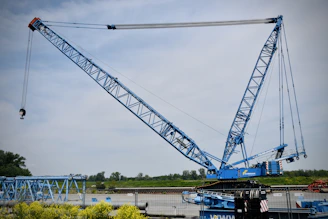 a large crane is lifting a piece of equipment