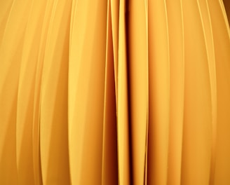 a close up of a yellow object with a black background