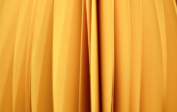 a close up of a yellow object with a black background