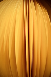 a close up of a yellow object with a black background