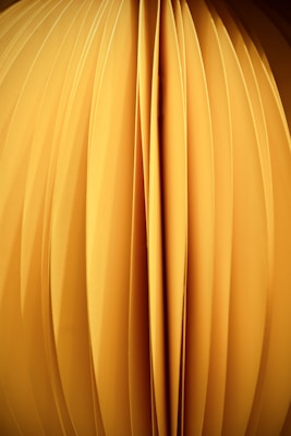 a close up of a yellow object with a black background