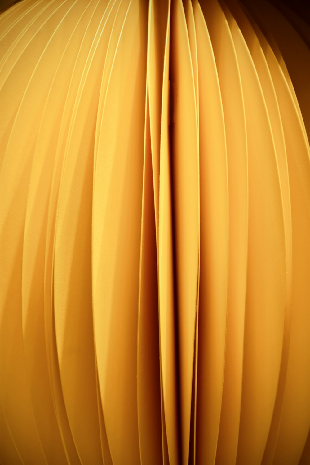 a close up of a yellow object with a black background