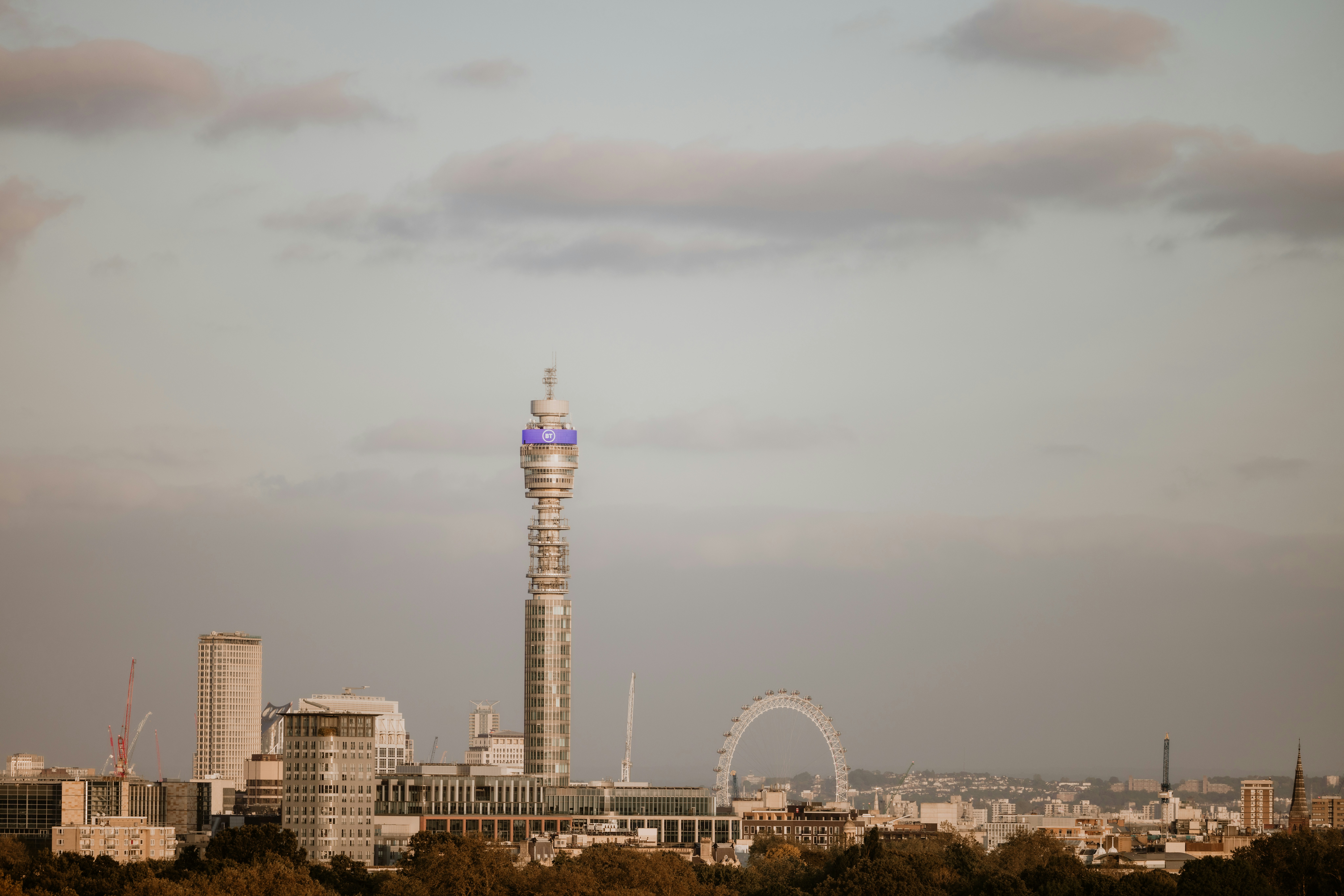 A tall tower with a blue top in the middle of a city