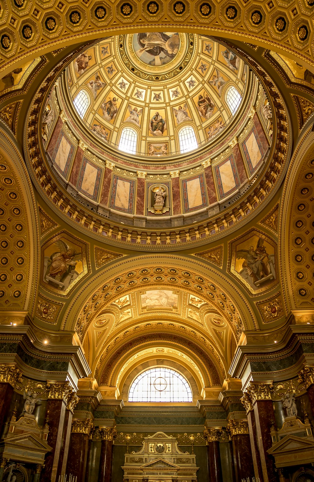 the ceiling of a large church with a clock on it