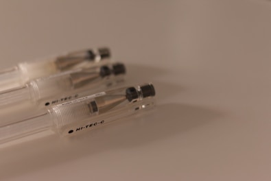 Close-up of smooth-writing pens with sleek designs laid out on a white background.