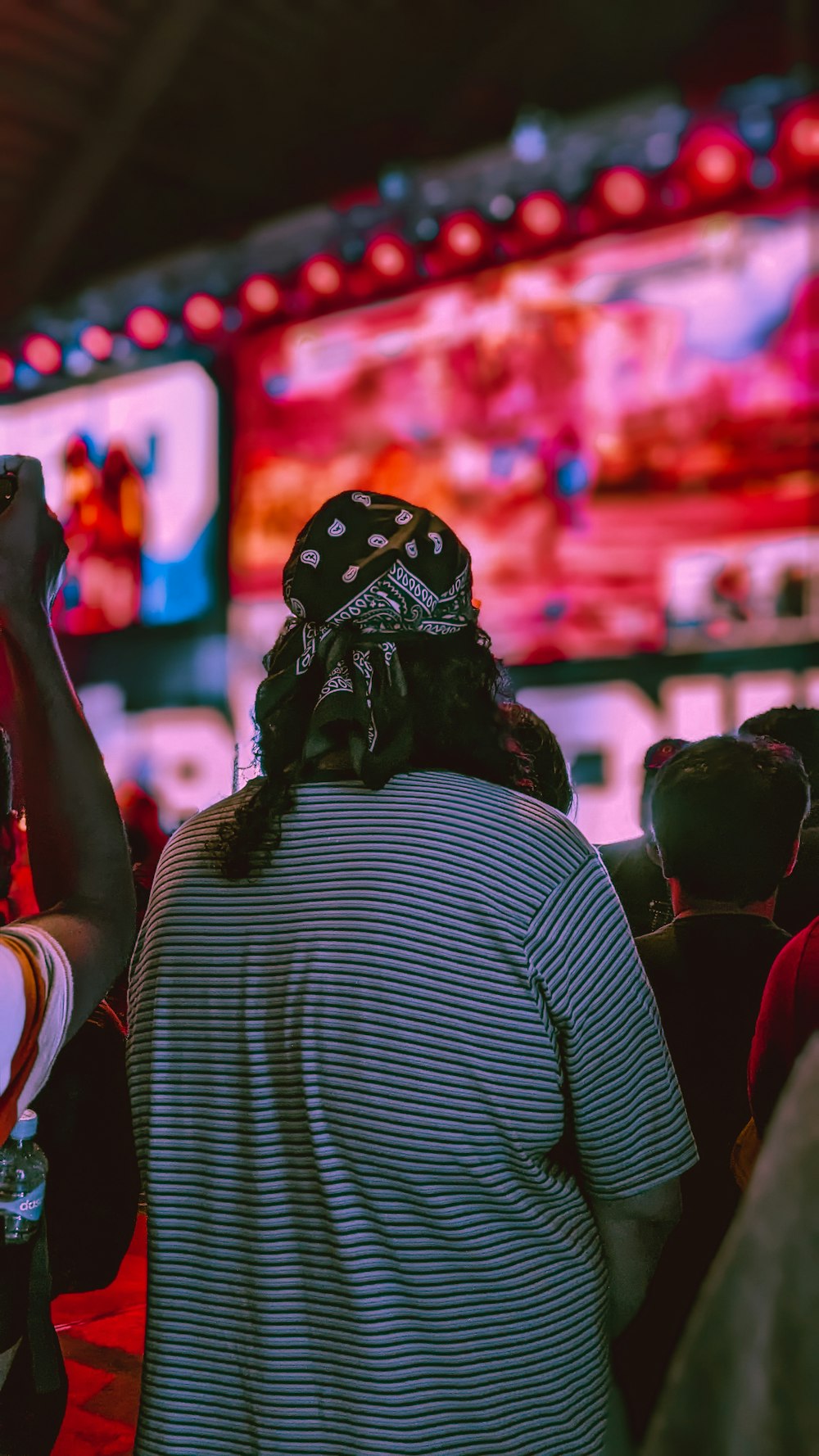 a group of people standing in front of a large screen