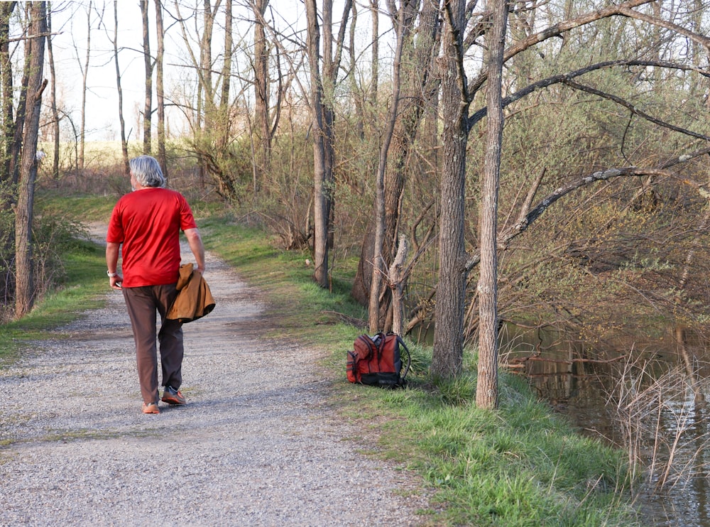 a person walking down a path in the woods