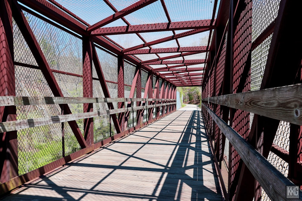 a red bridge with a wooden walkway going across it
