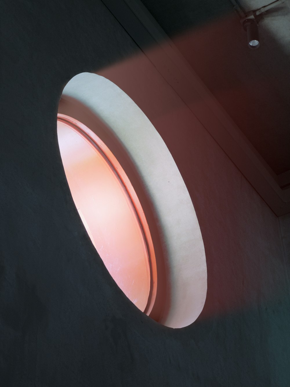 a round light that is on the side of a wall