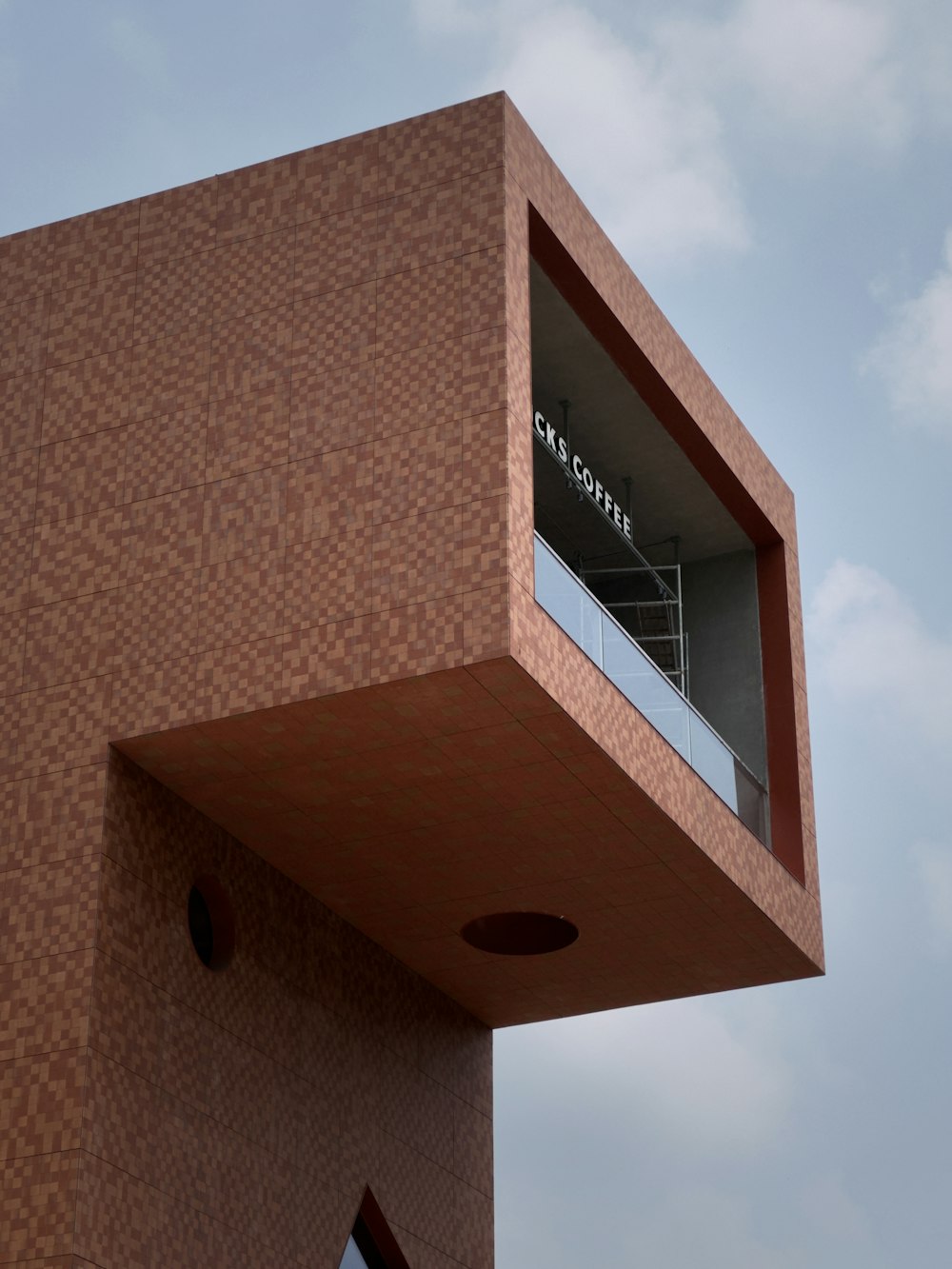 a tall building with a balcony and a balcony