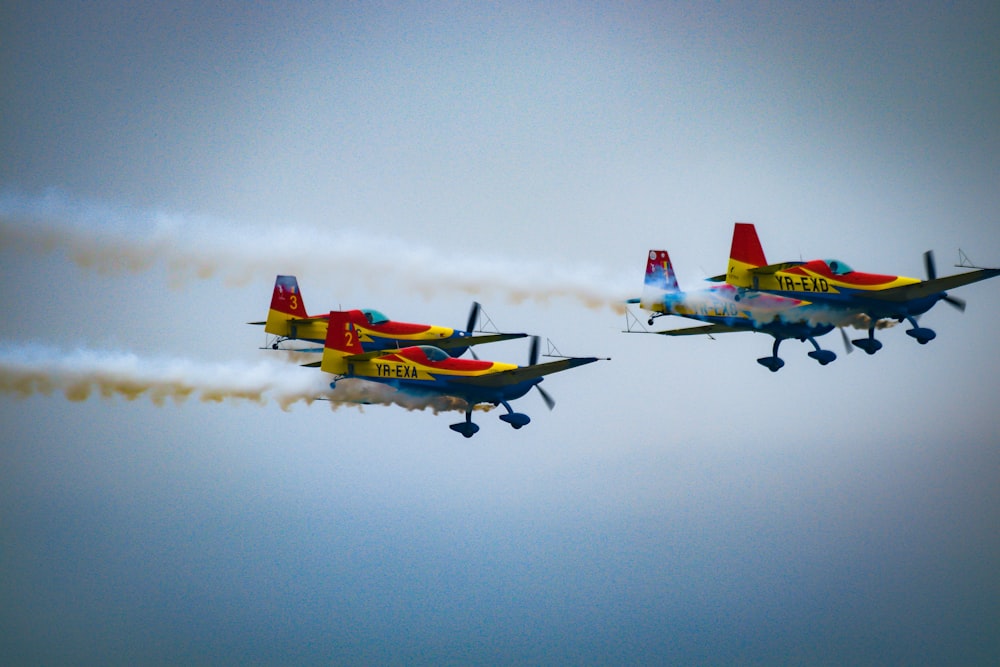 two airplanes flying in the sky with smoke coming out of them