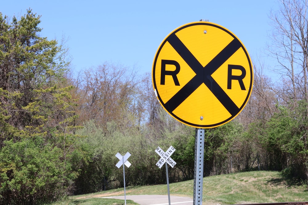 a railroad crossing sign on the side of the road