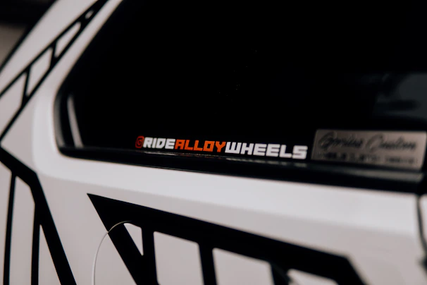 Close-up of glossy, durable decals applied smoothly on a delivery van.