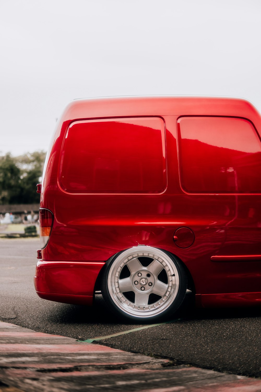 a red van parked in a parking lot