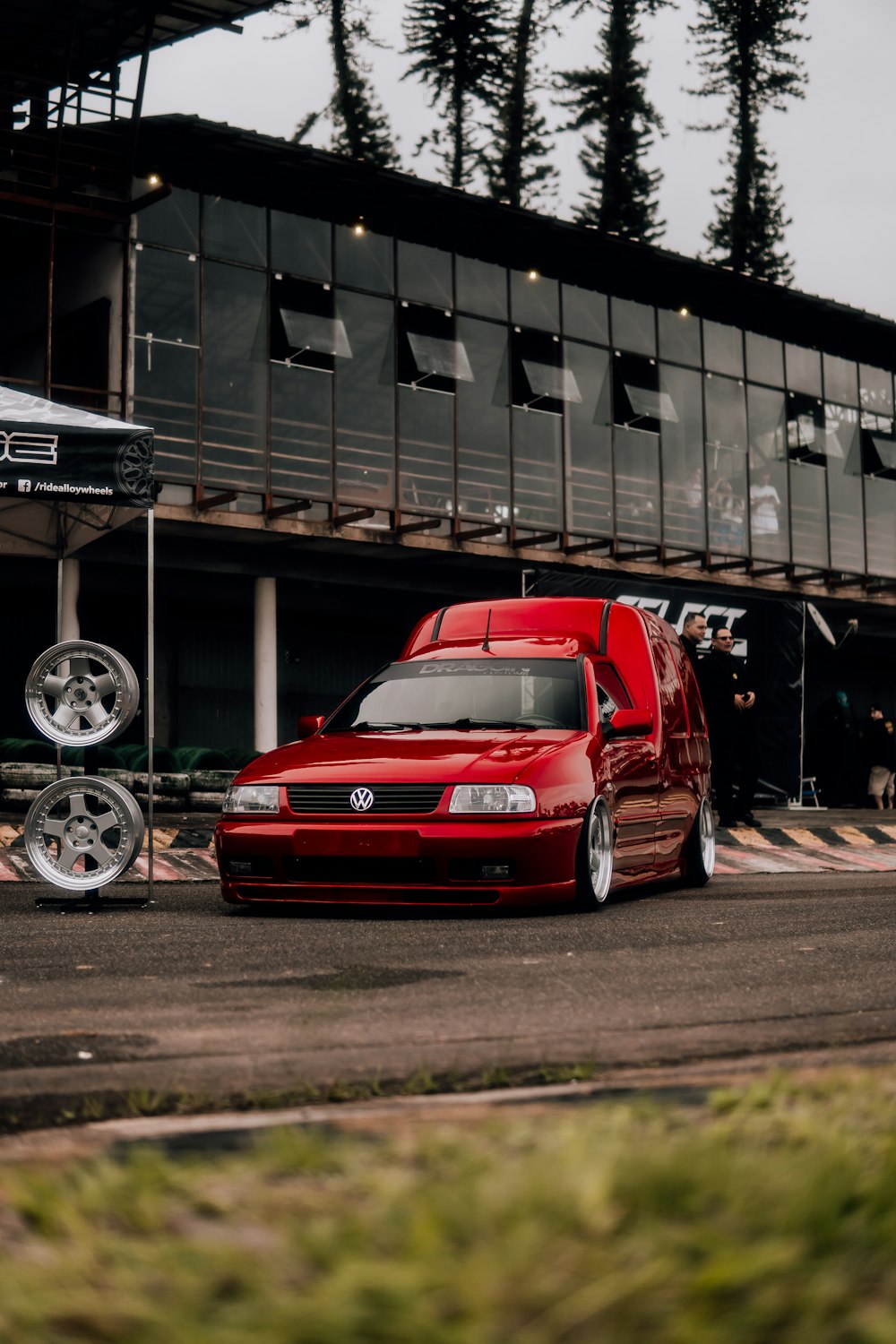 a red car parked in front of a building