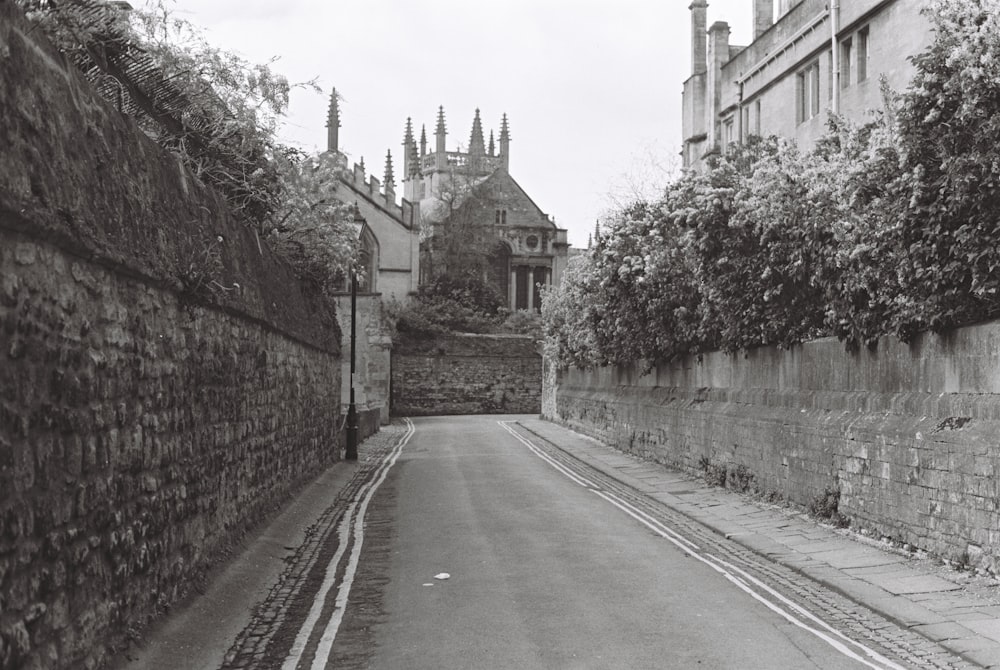 a black and white photo of a narrow street