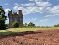 View from the cafe window showcasing the lush green grounds of nearby Tattershall Castle under a blue sky.