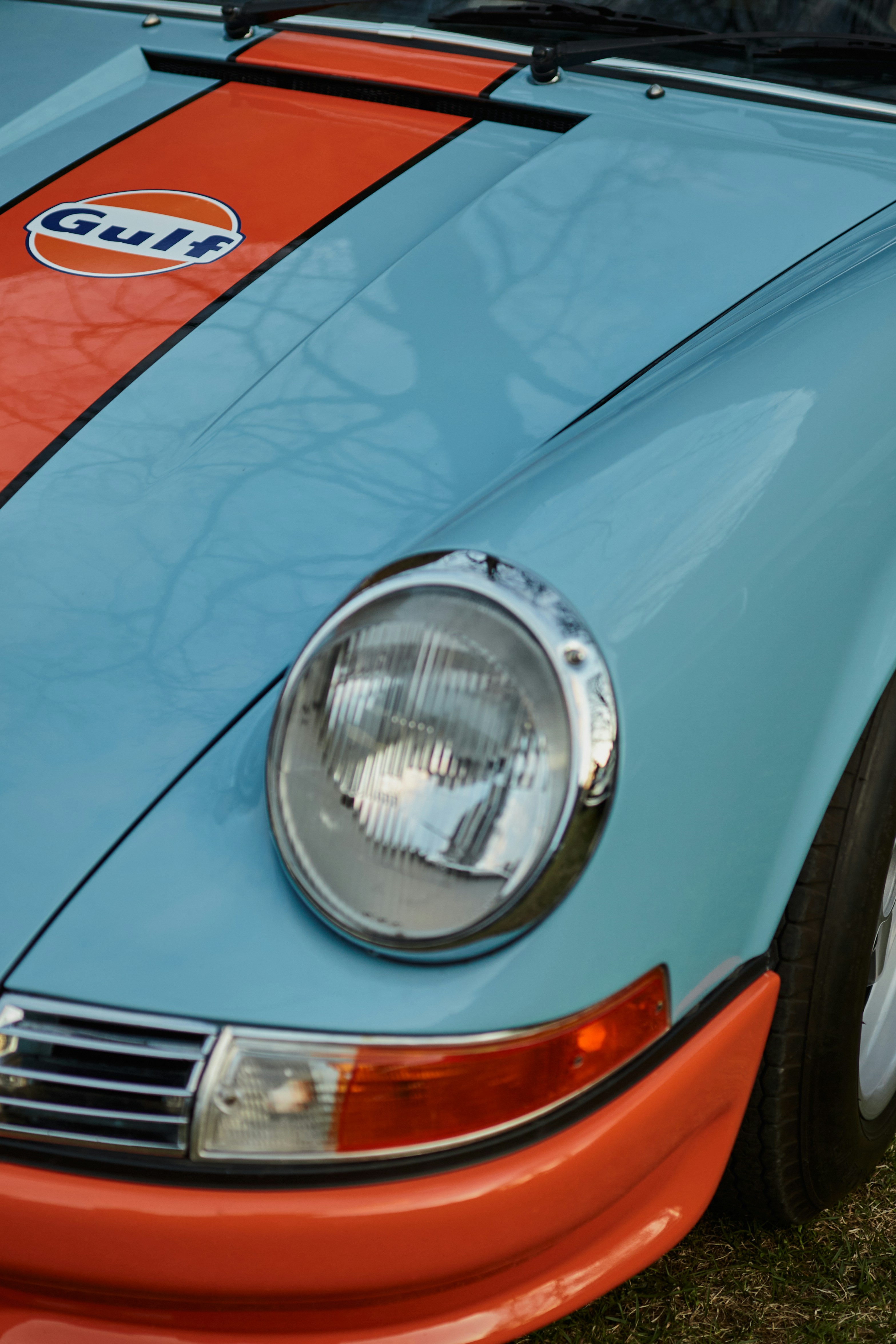 a close up of a blue and orange sports car