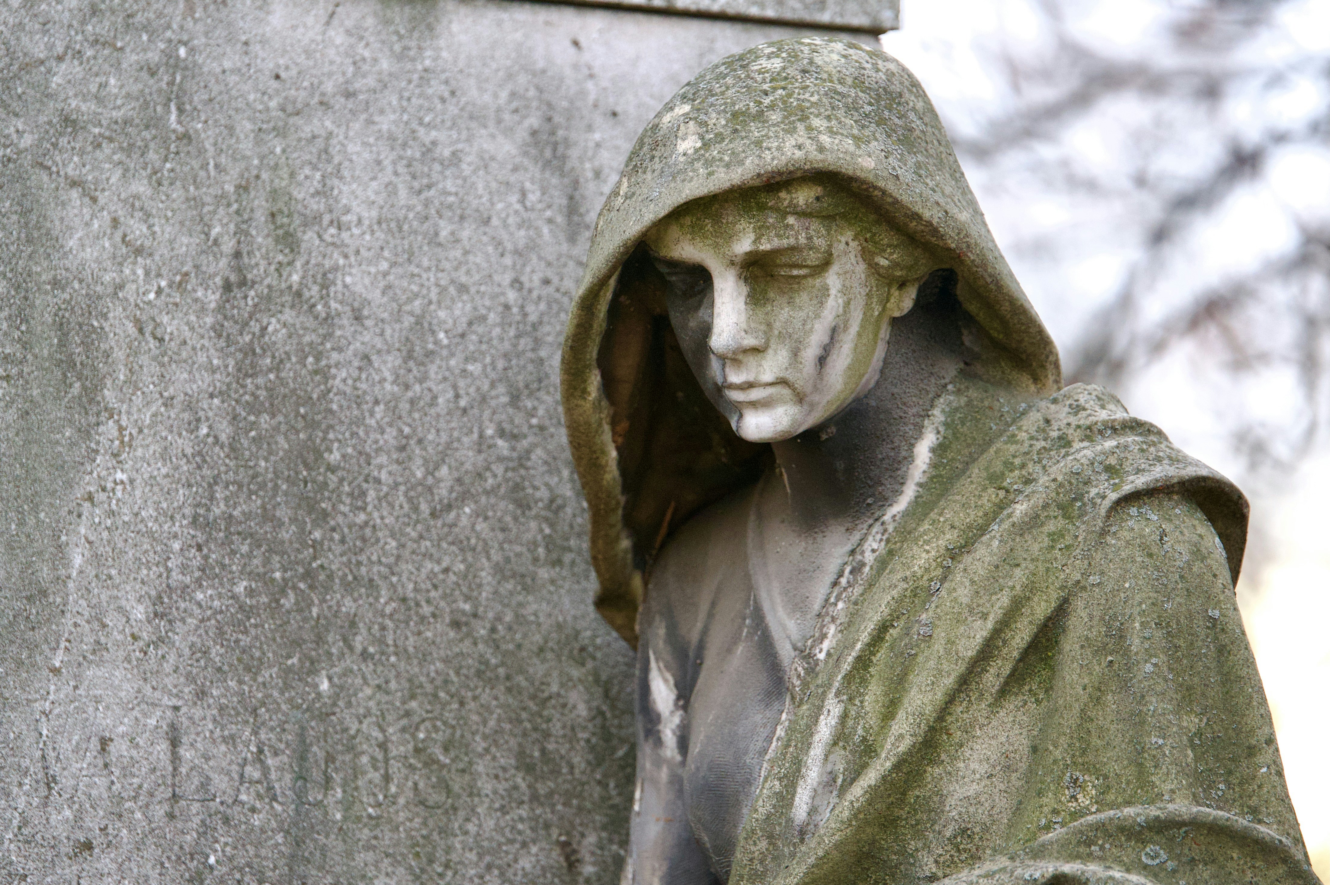 a statue of a man with a hood on