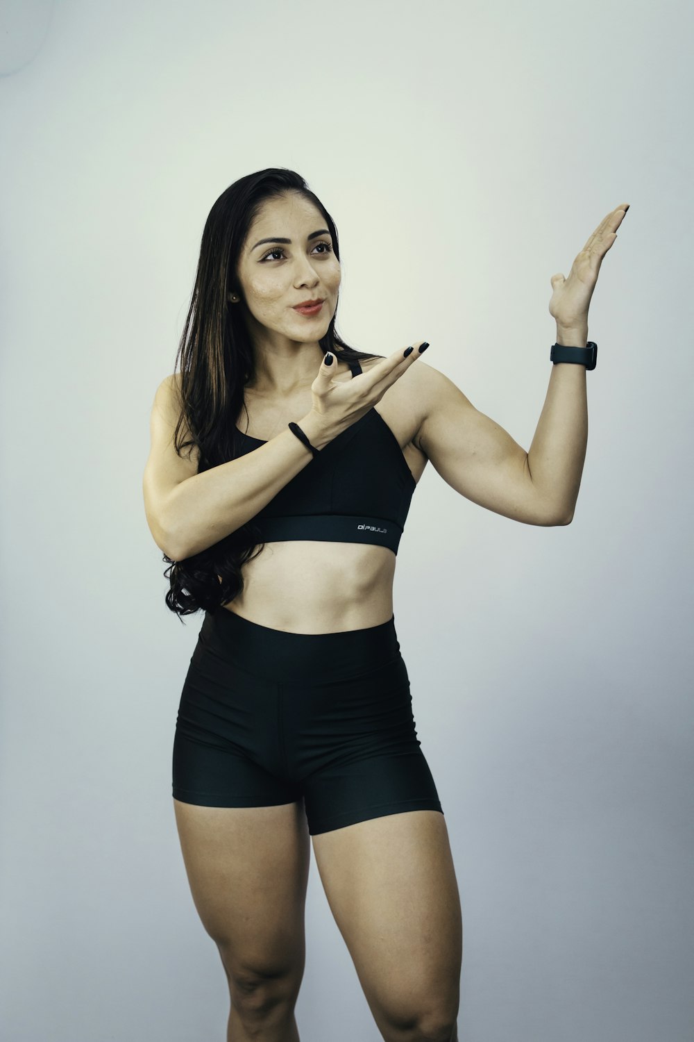 a woman in a black top and black shorts
