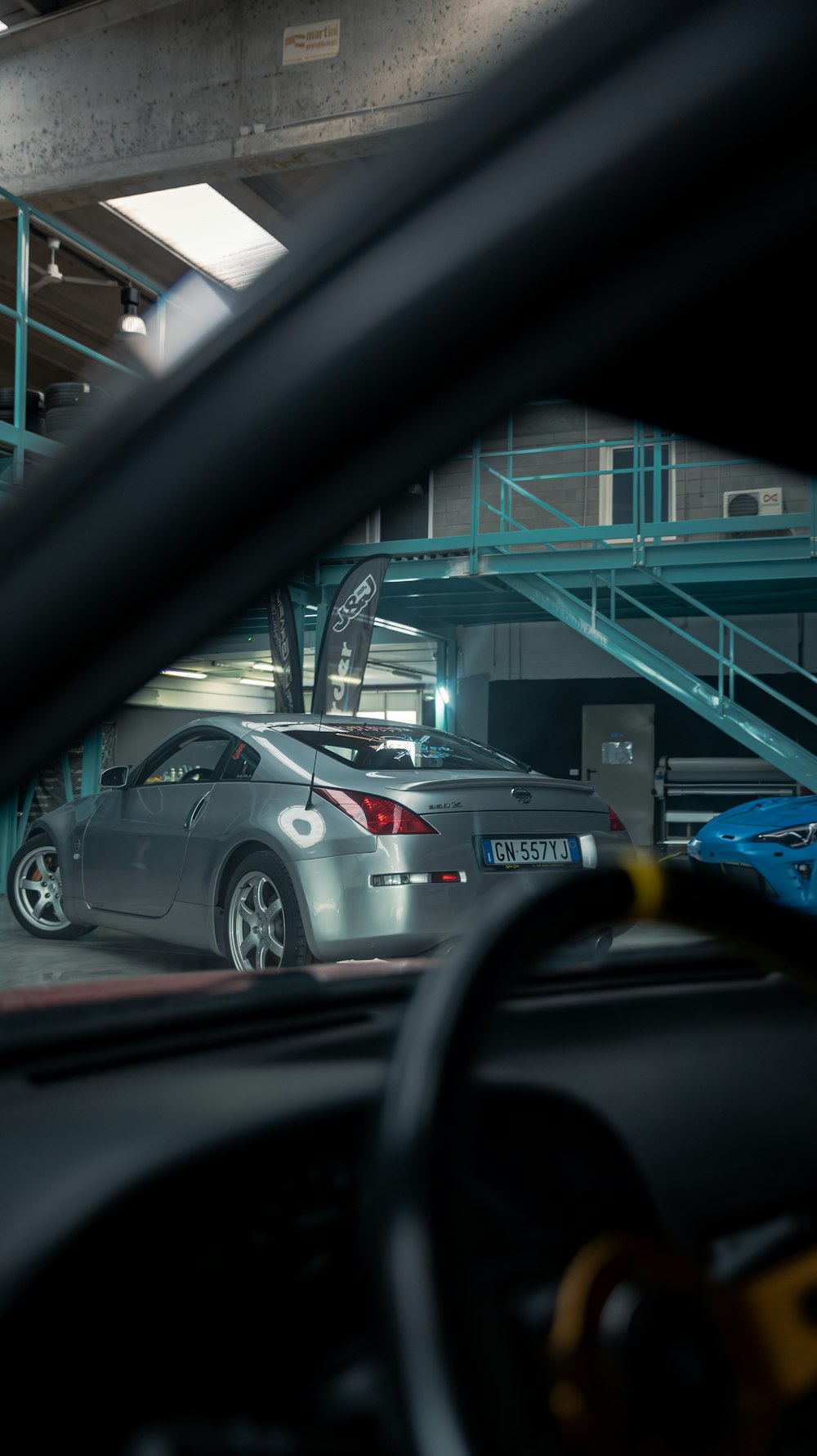 a car parked in a parking garage next to another car