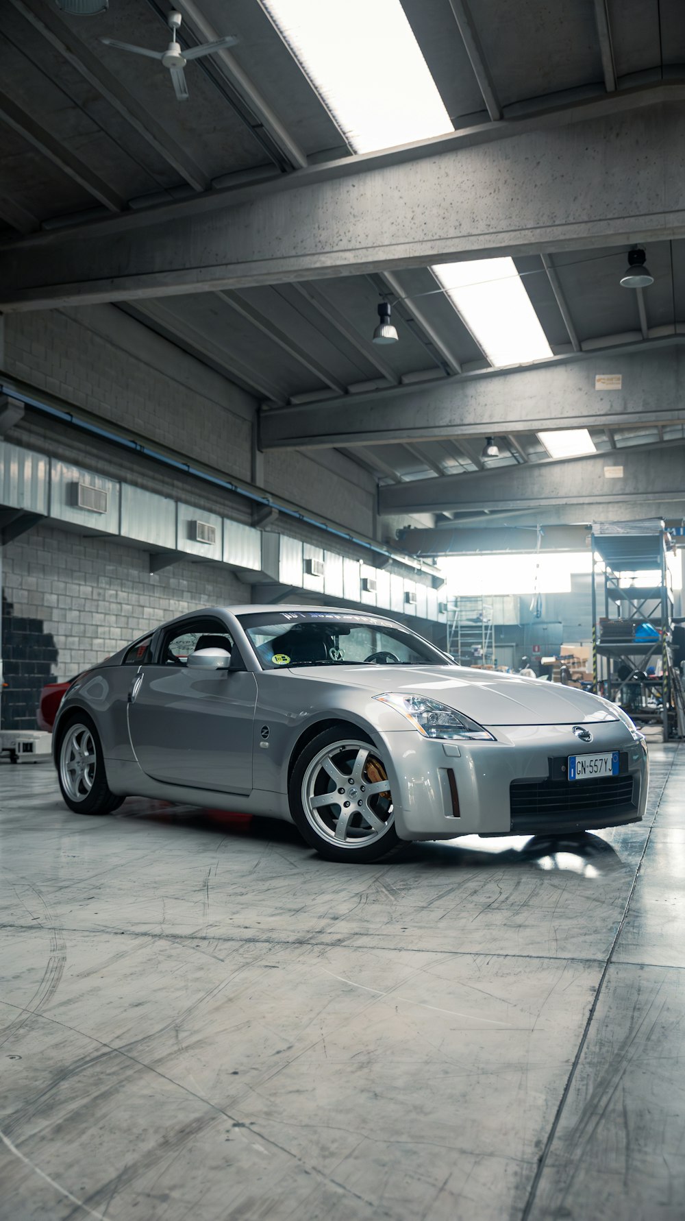 a silver sports car parked in a garage