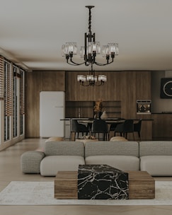a living room filled with furniture and a chandelier