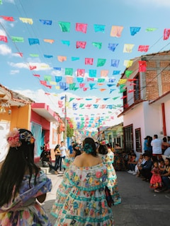 Women dressed in traditional Semana Santa attire walking in the streets of Seville during Holy Thursday.