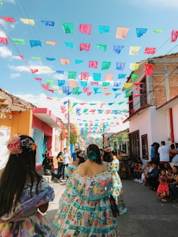 A group of women dressed in traditional Semana Santa attire, walking together in Seville on Holy Thursday.