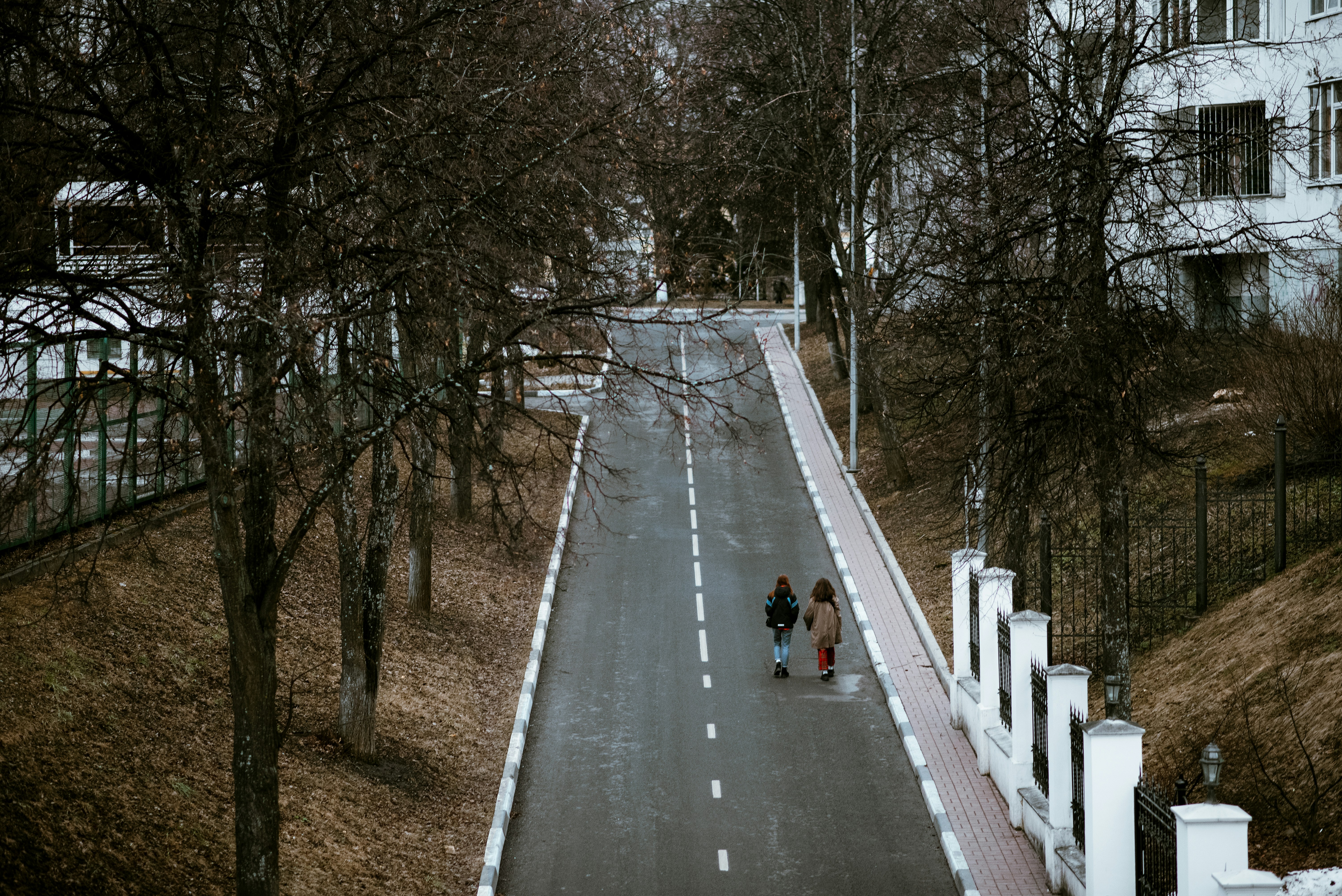 a couple of people walking down a street