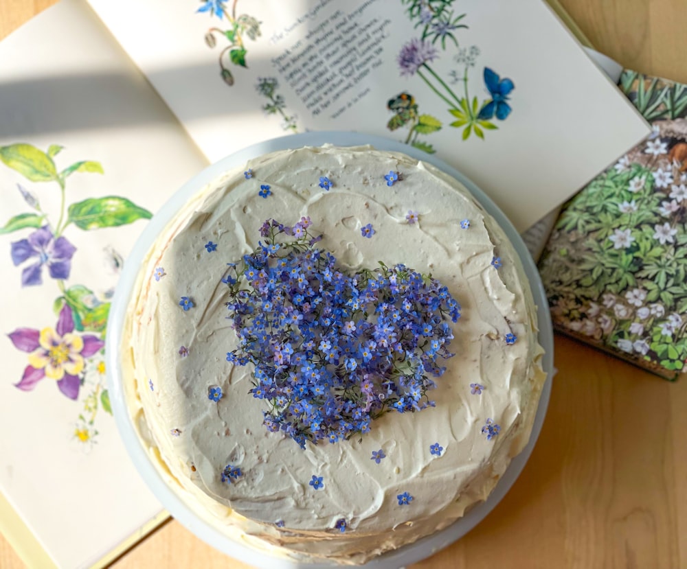 a cake sitting on top of a table next to a book