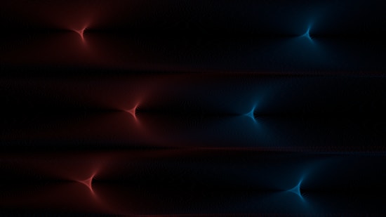 A digital artwork featuring symmetrical, glowing patterns resembling starbursts. The left side displays red hues while the right side shifts to blue, set against a dark background.