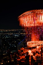 A glamorous rooftop party with well-dressed avatars enjoying the night skyline.