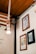 A cozy corner with soft natural light illuminating a framed painting on the wall.