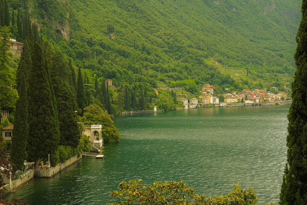 a lake surrounded by a lush green hillside