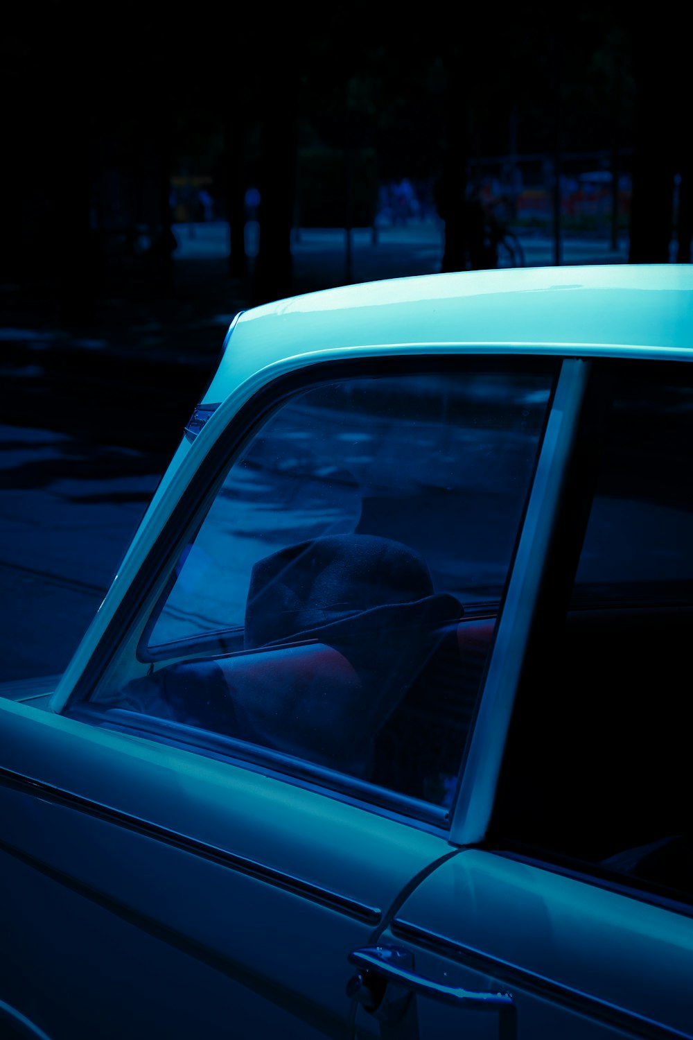 a person sitting in a car in the dark