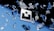 Floating geometric shapes, resembling shattered glass, are suspended around a central logo against a backdrop transitioning from black to blue. The scene conveys a sense of motion and fragmentation.