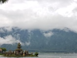 A serene temple surrounded by lush greenery and pilgrims.