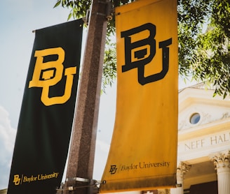 a couple of banners hanging from the side of a building