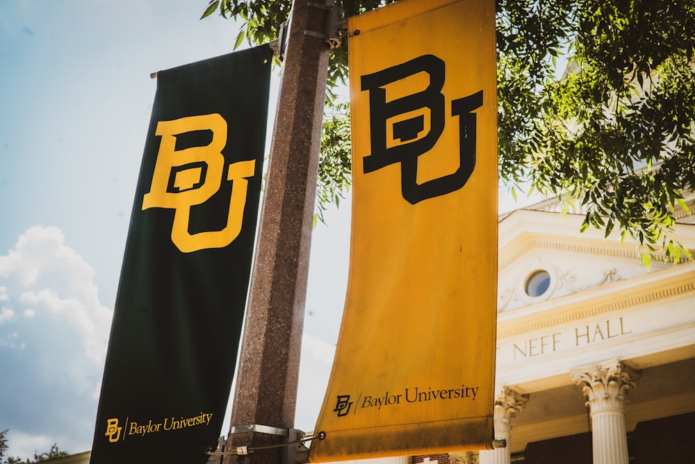 a couple of banners hanging from the side of a building