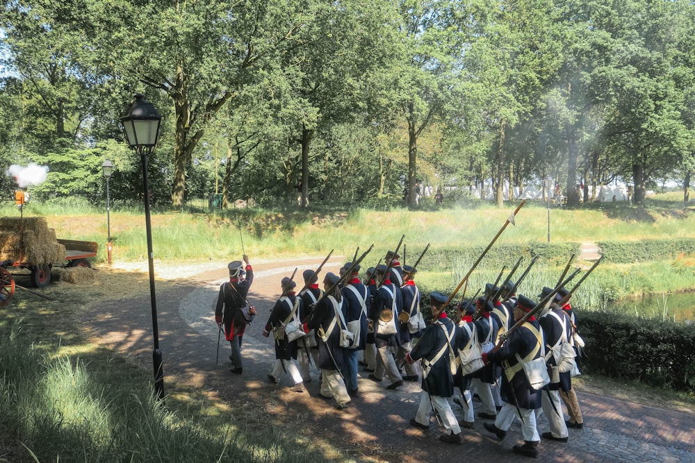 a group of men in uniforms marching down a street