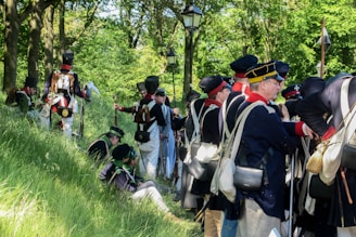 A group of scouts engaged in a colonial-themed outdoor game, with historical costumes and wooden props