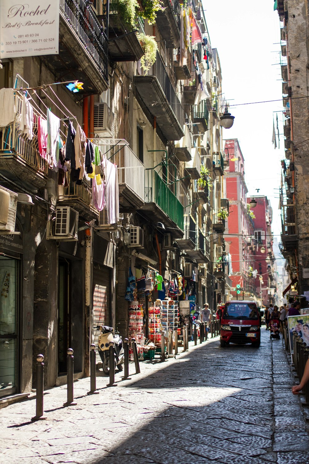 a city street lined with tall buildings with balconies