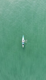 a person in a kayak in the middle of a body of water
