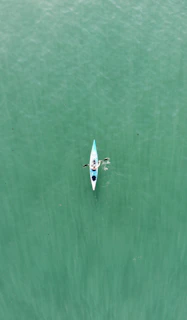 a person in a kayak in the middle of a body of water